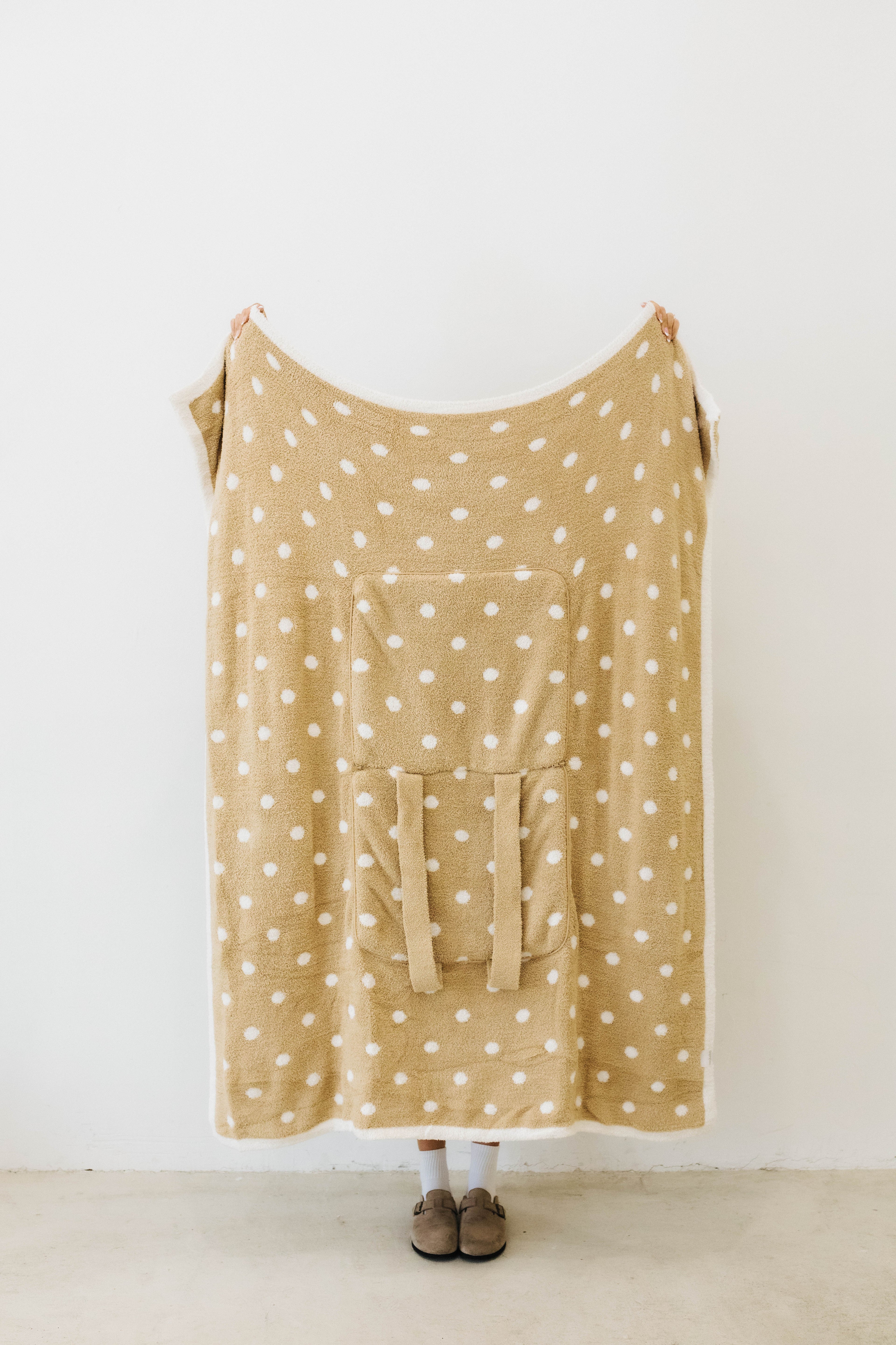 back of polka dot quillow opened tan with white polka dots