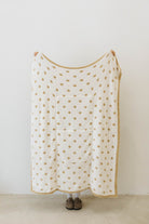 polka dot quillow opened on white side with tan polka dots