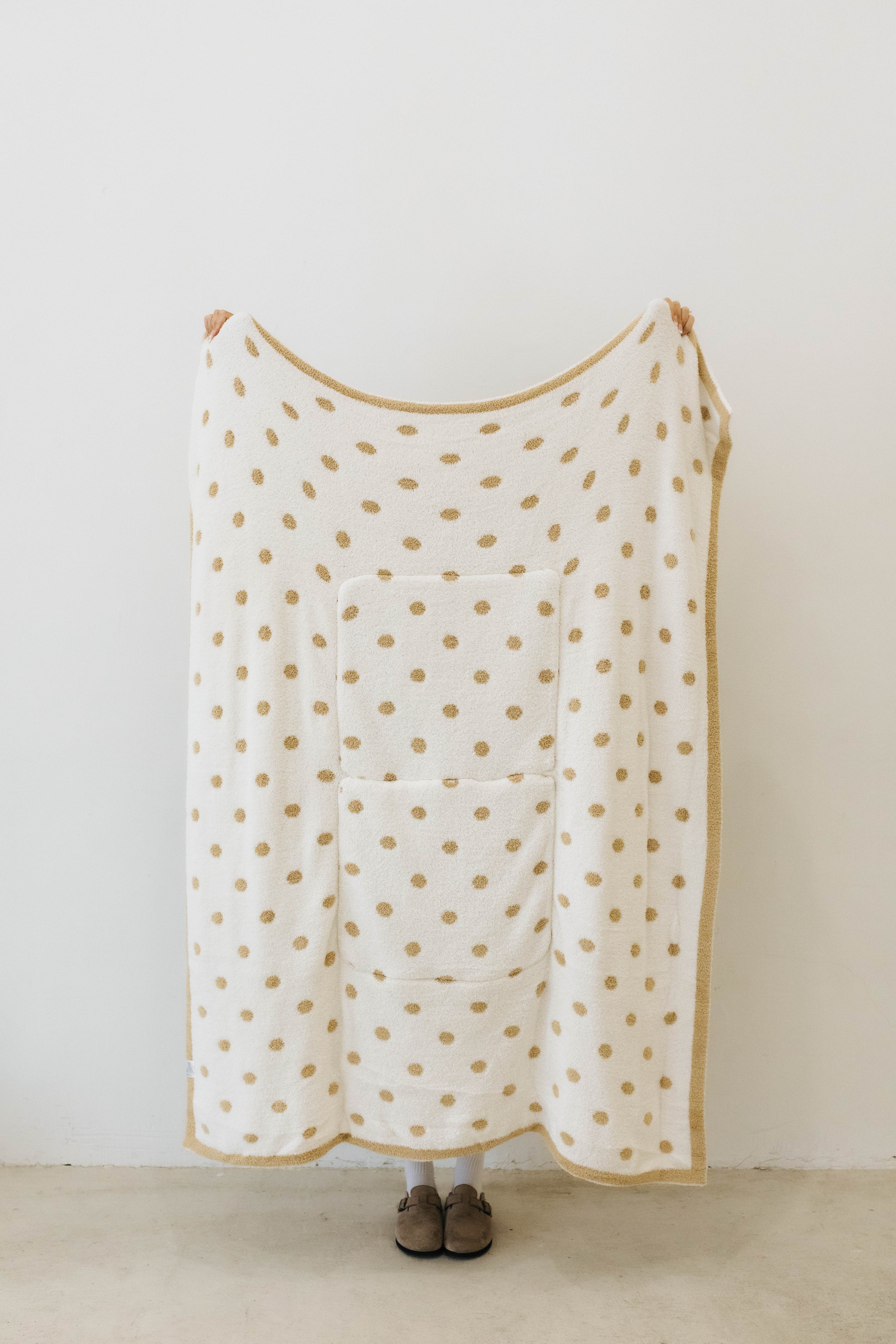 polka dot quillow opened on white side with tan polka dots