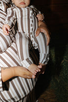 Close view of the striped baby zip pajamas and covered feet.