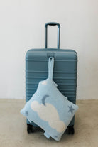 cloud backpack/wristlet quillow hanging on suitcase