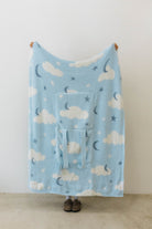 cloud backpack/wristlet quillow opened showing one side of the quillow showing moon, cloud, and star print 