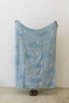 cloud backpack/wristlet quillow opened showing one side of the quillow showing moon, cloud, and star print 