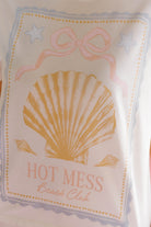 Product packaging with a shell design and 'Hot Mess Beach Club' text on a light background.