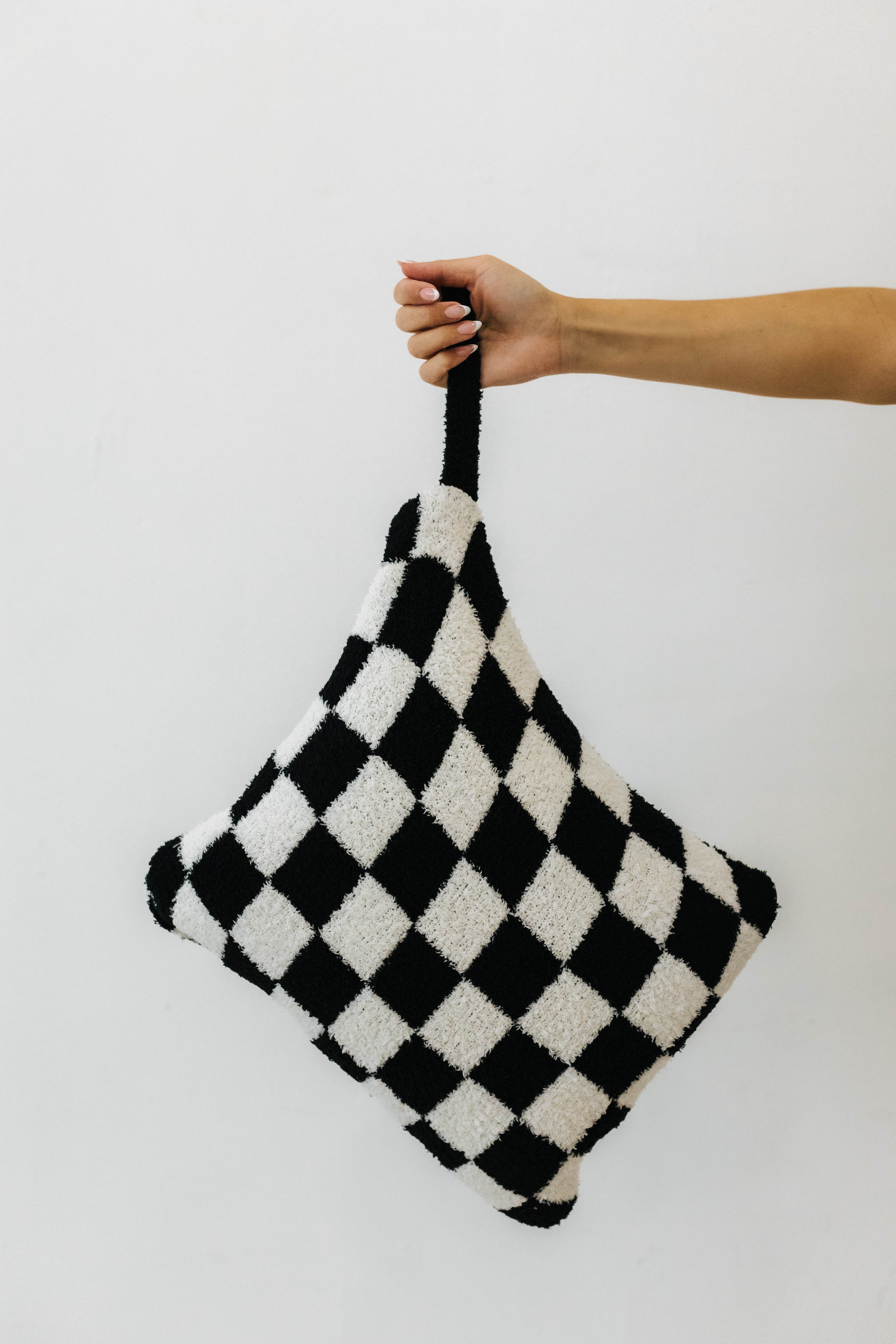model holding wristlet of black check quillow