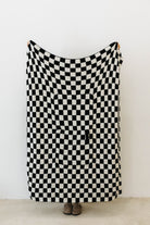 one side of black check quillow showing black and white checkered print 