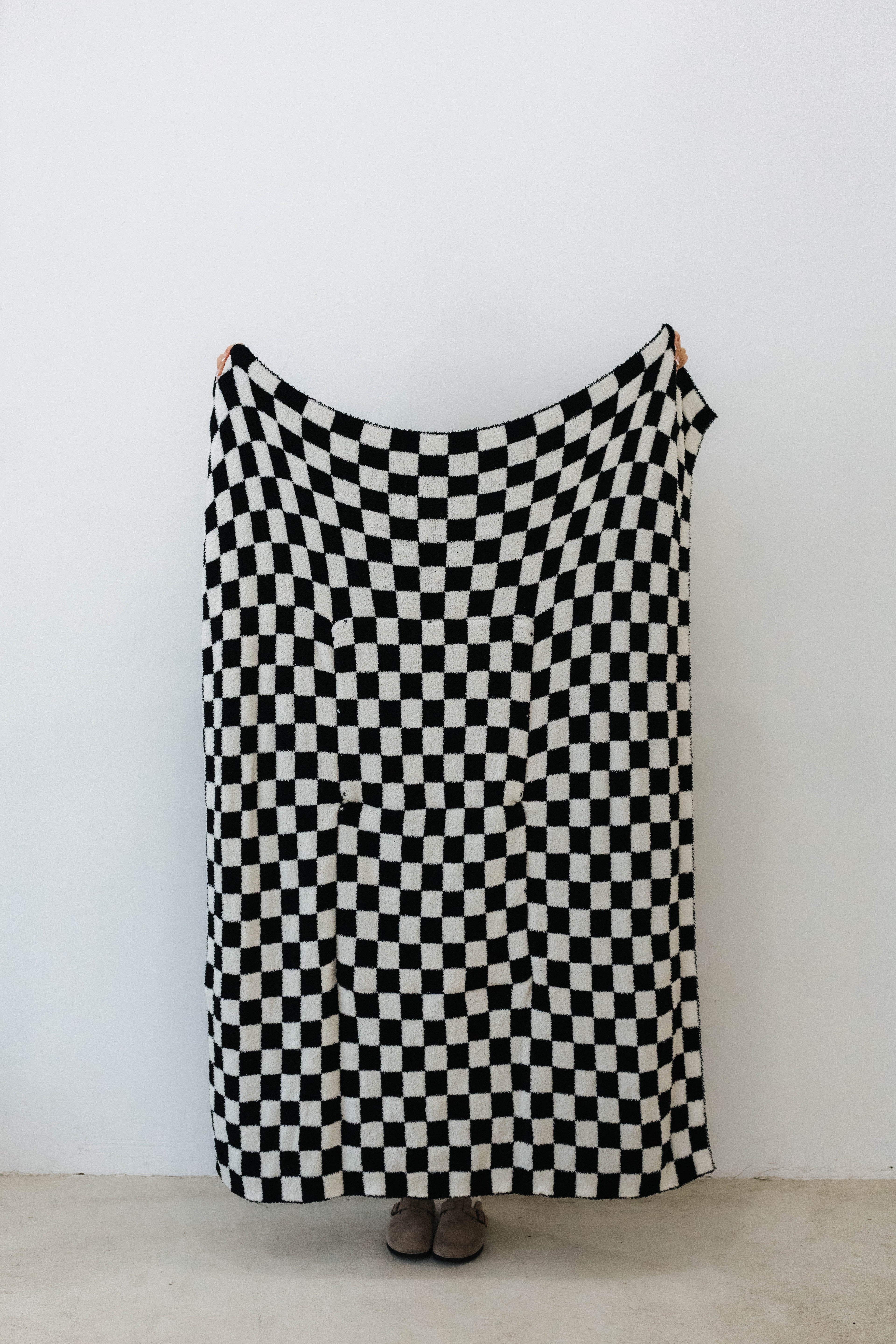 one side of black check quillow showing black and white checkered print 