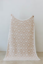 pumpkin blanket showing one side of the blanket the print has pumpkins, flowers, and bows 