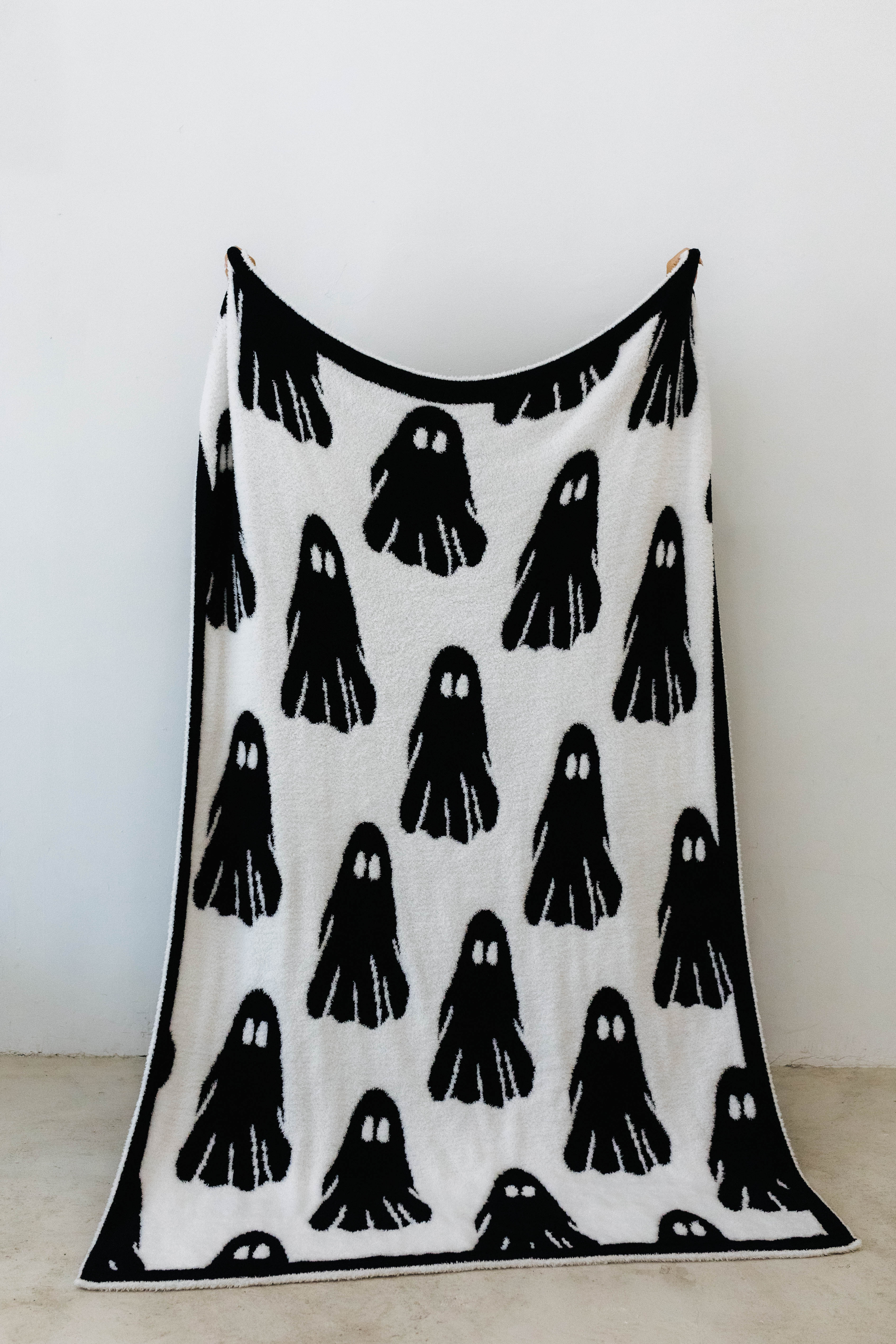 ghost blanket opened showing the black and white ghosts