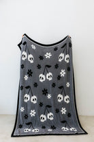 one side of skelly blanket showing skelly cherry print and flowers 