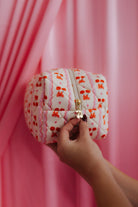 hand showing the cherry detail on the zipper