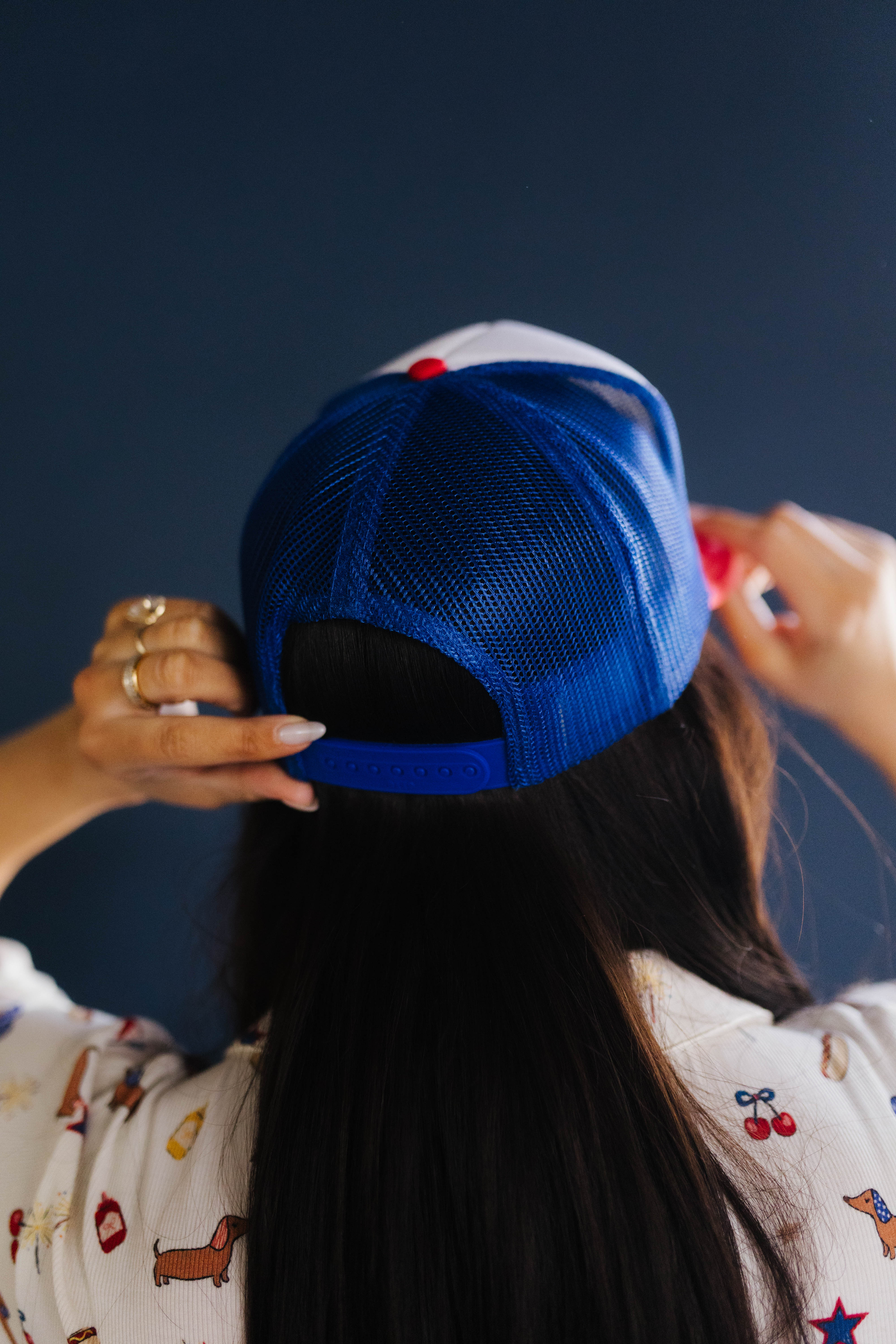 Person wearing a blue cap with a dark background