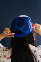 Person wearing a blue cap with a dark background