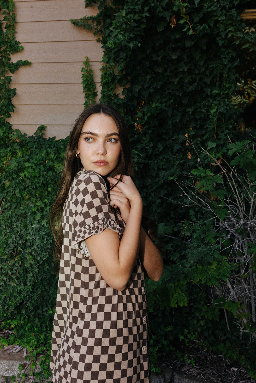 Side and back view of the adult brown check pajama shirt and shorts.