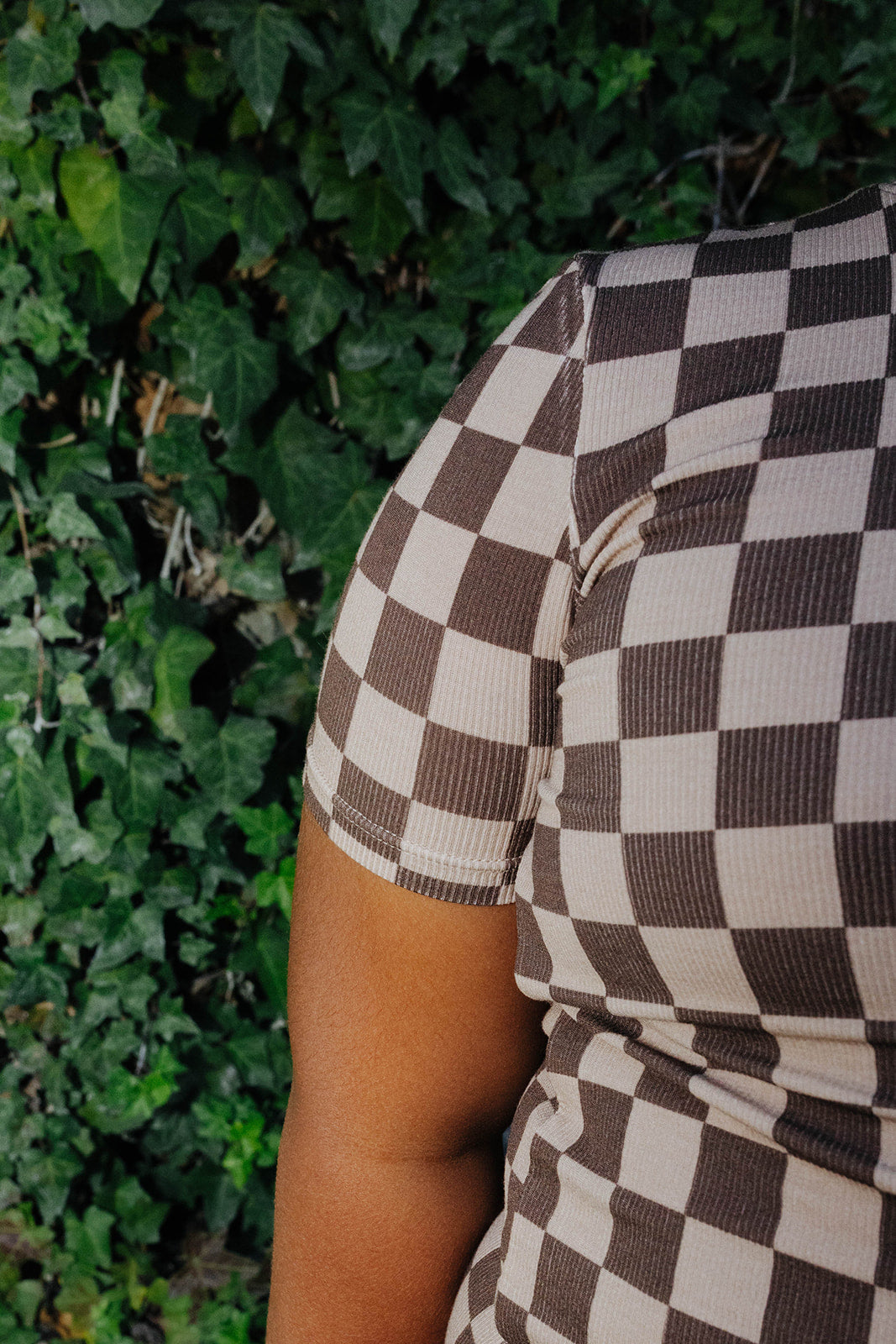 Close view of the brown check print on a kid pajama sleeve.