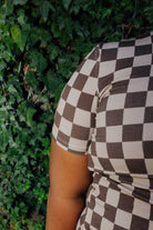 Close view of the brown check print on a kid pajama sleeve.