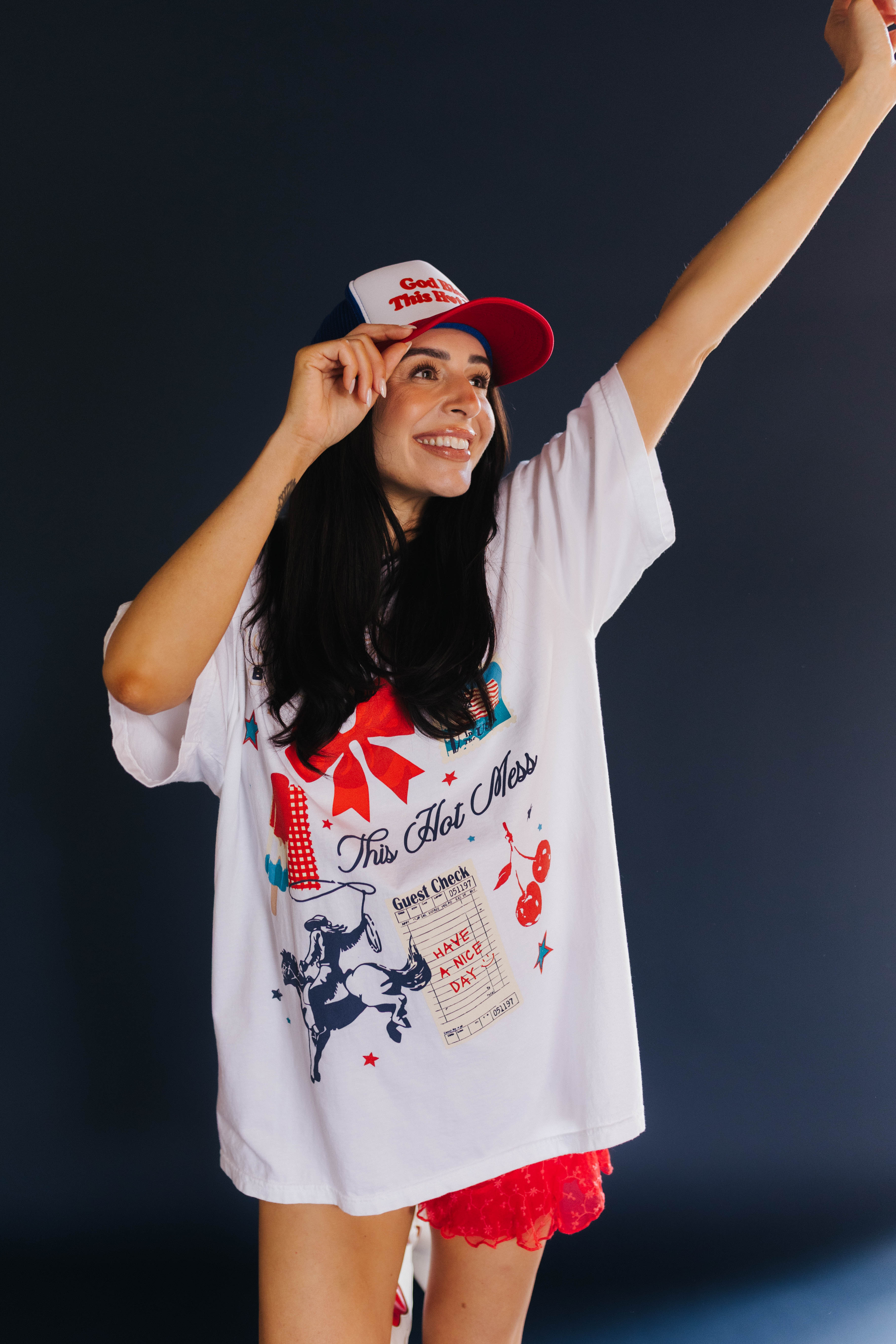 Woman wearing a white graphic t-shirt and red shorts with a dark background