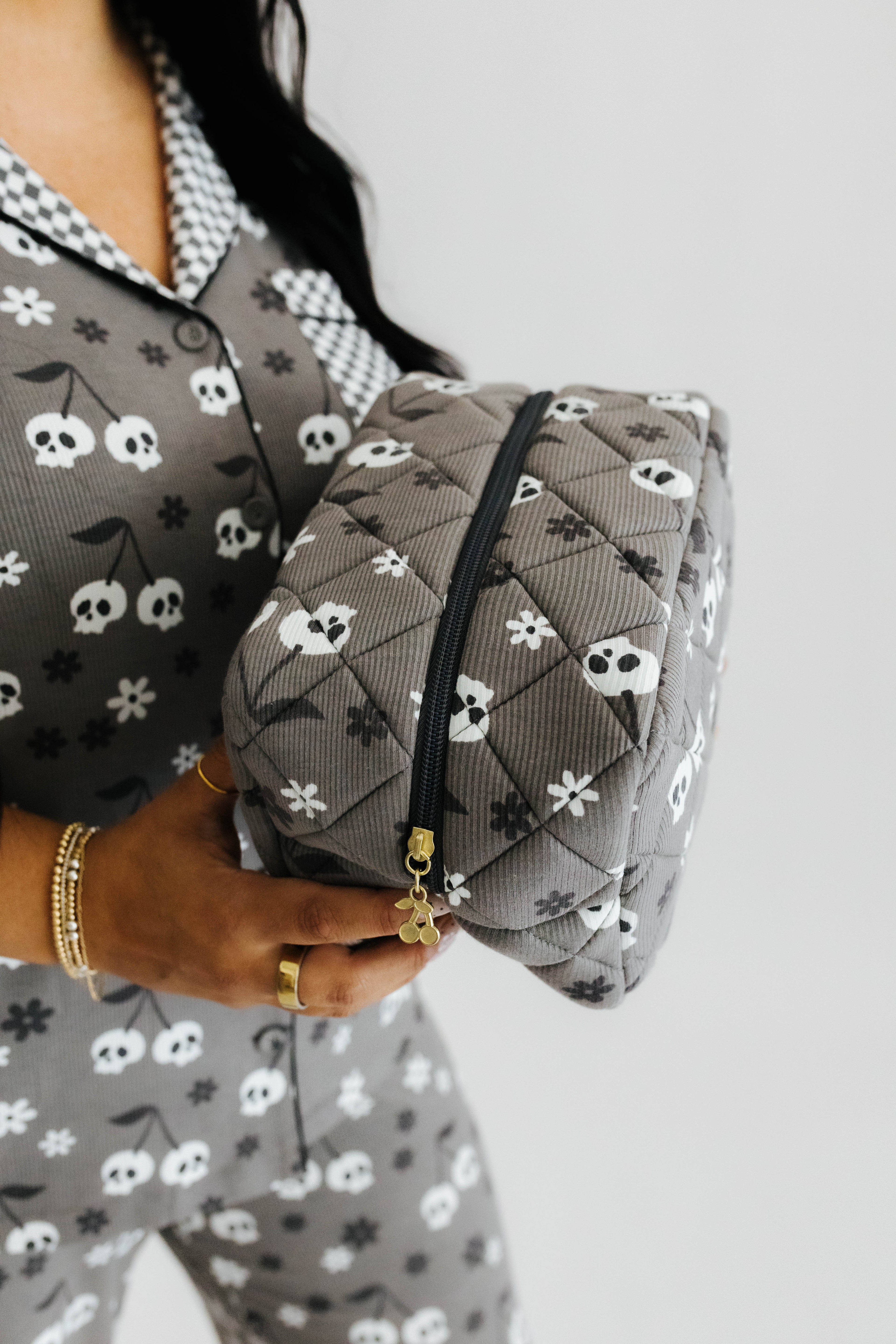 model holding skelly cosmetic bag