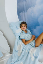 model kolly laying on the moon decoration with the cloud baby blanket and cloud backpack/wristlet quillow 