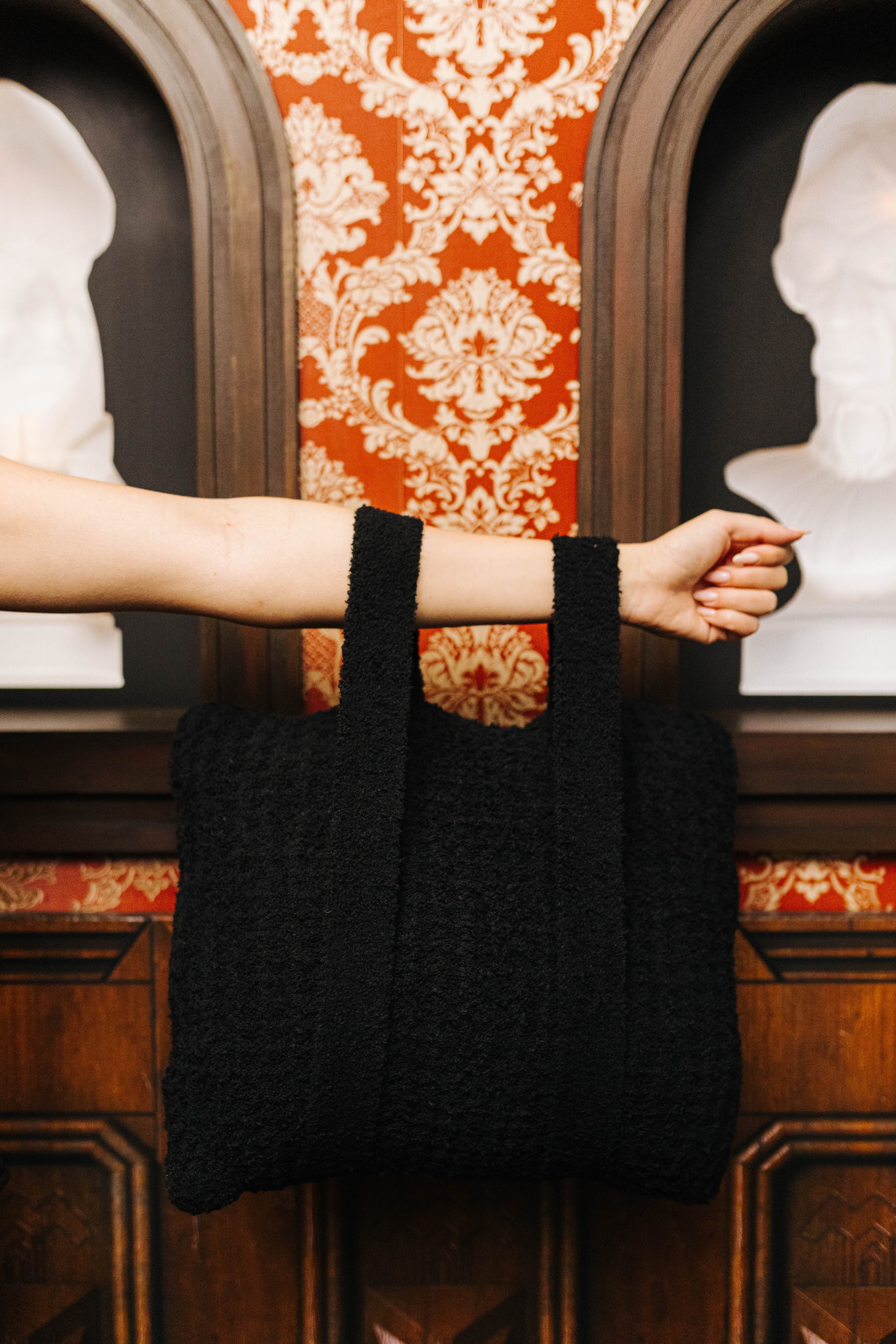 Black waffle quillow carried by its handles