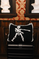 Skelly quillow folded into a pillow on a suitcase