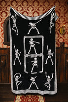 Skelly quillow unfolded to show the black skeleton side