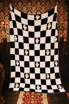 Ghost Check blanket held open to show the full pattern