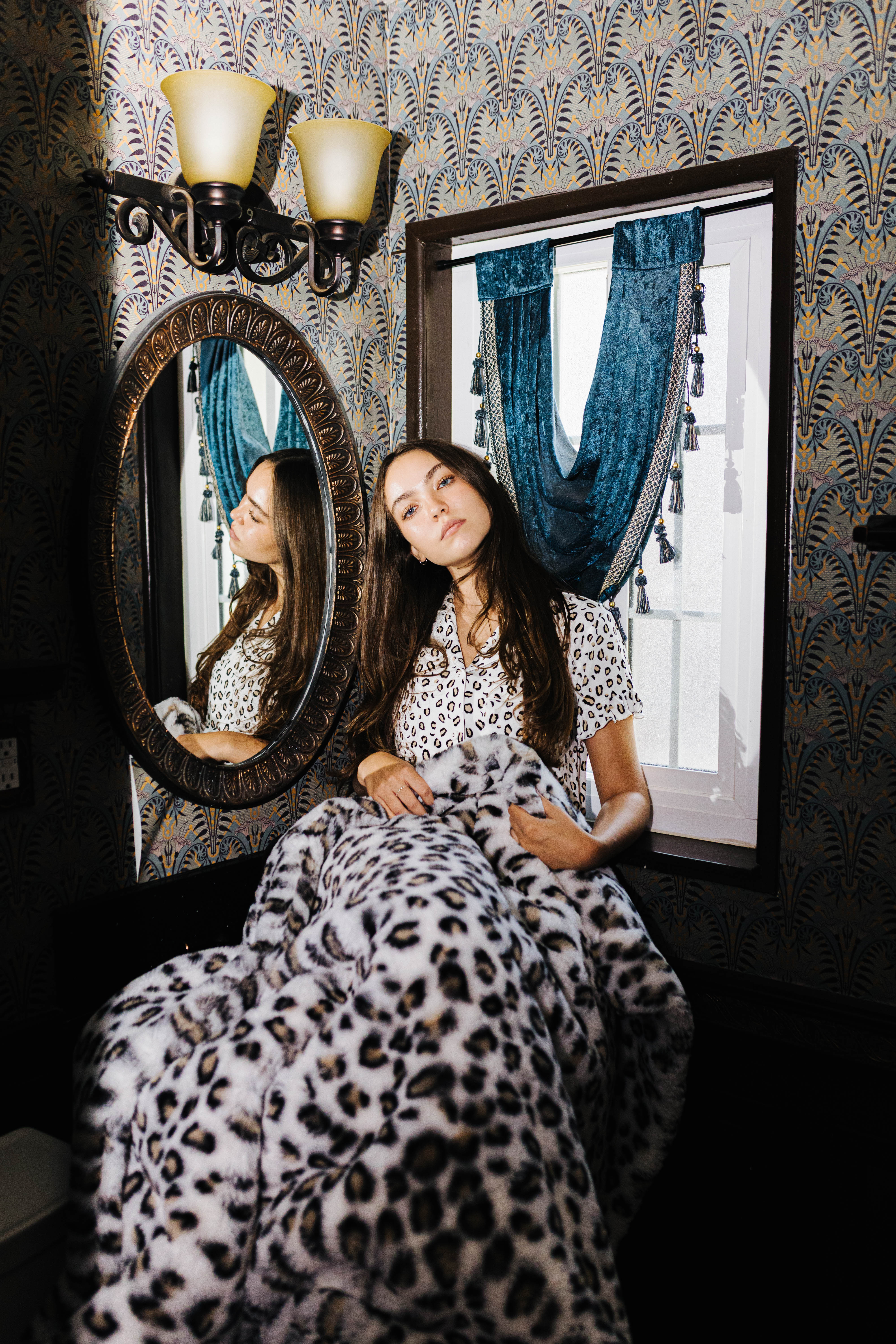 Leopard Faux Fur Blanket 60x80 shown in a full length lifestyle view
