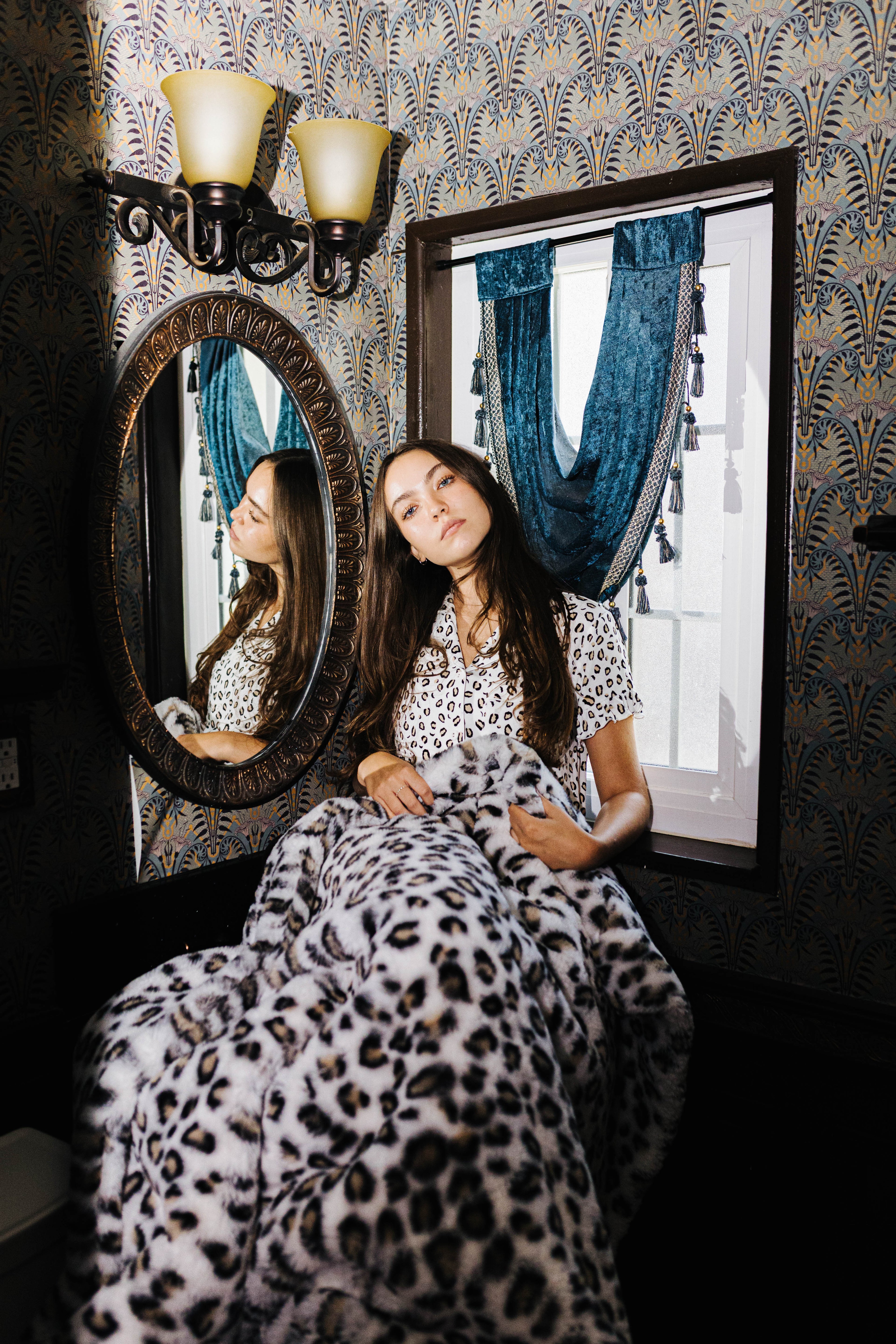 Leopard Faux Fur Blanket 60x80 shown in a full length lifestyle view