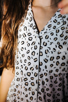 Close view of the collar and buttons on the leopard pajama top