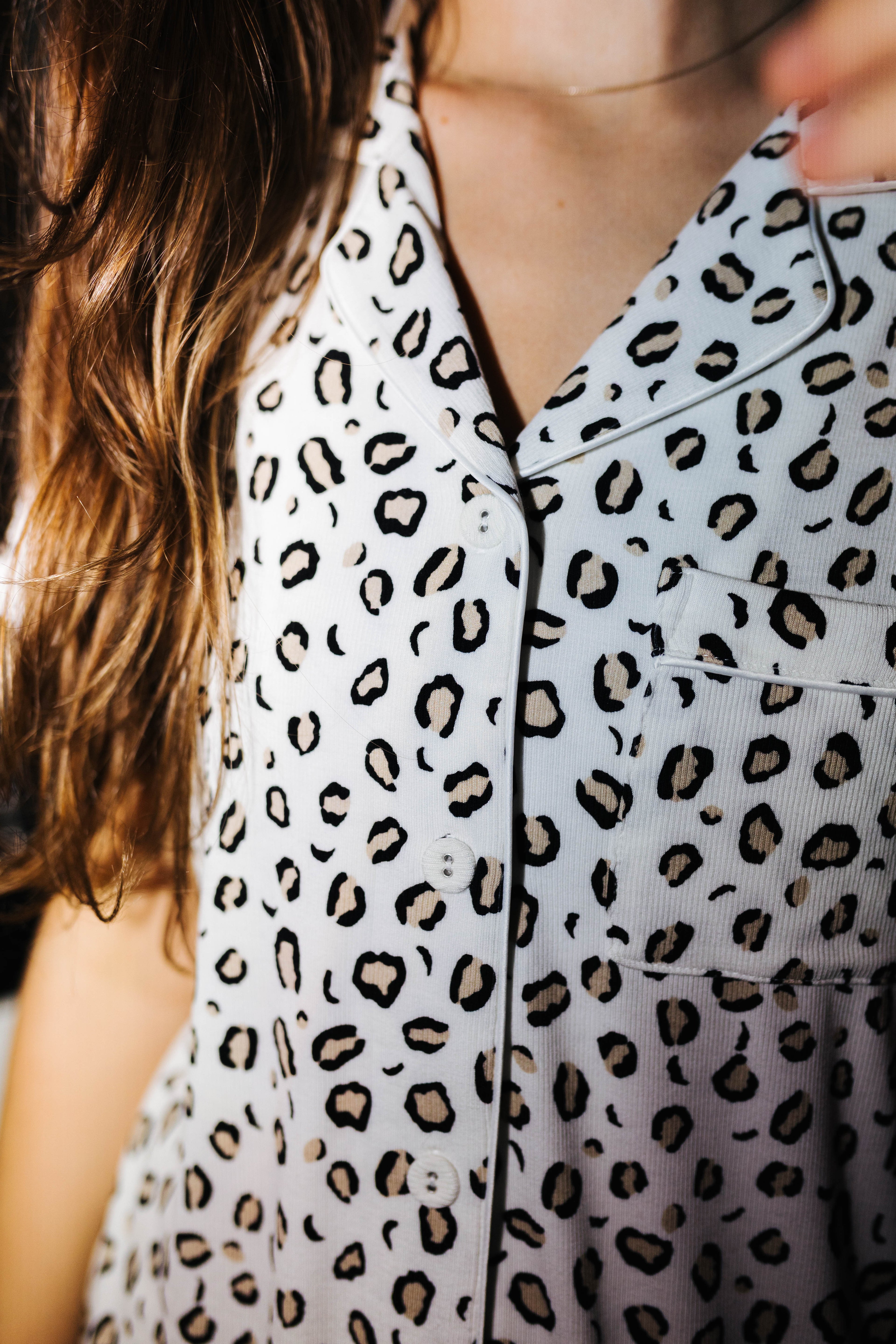 Close view of the collar and buttons on the leopard pajama top
