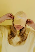 Yellow dad hat that says homebody 