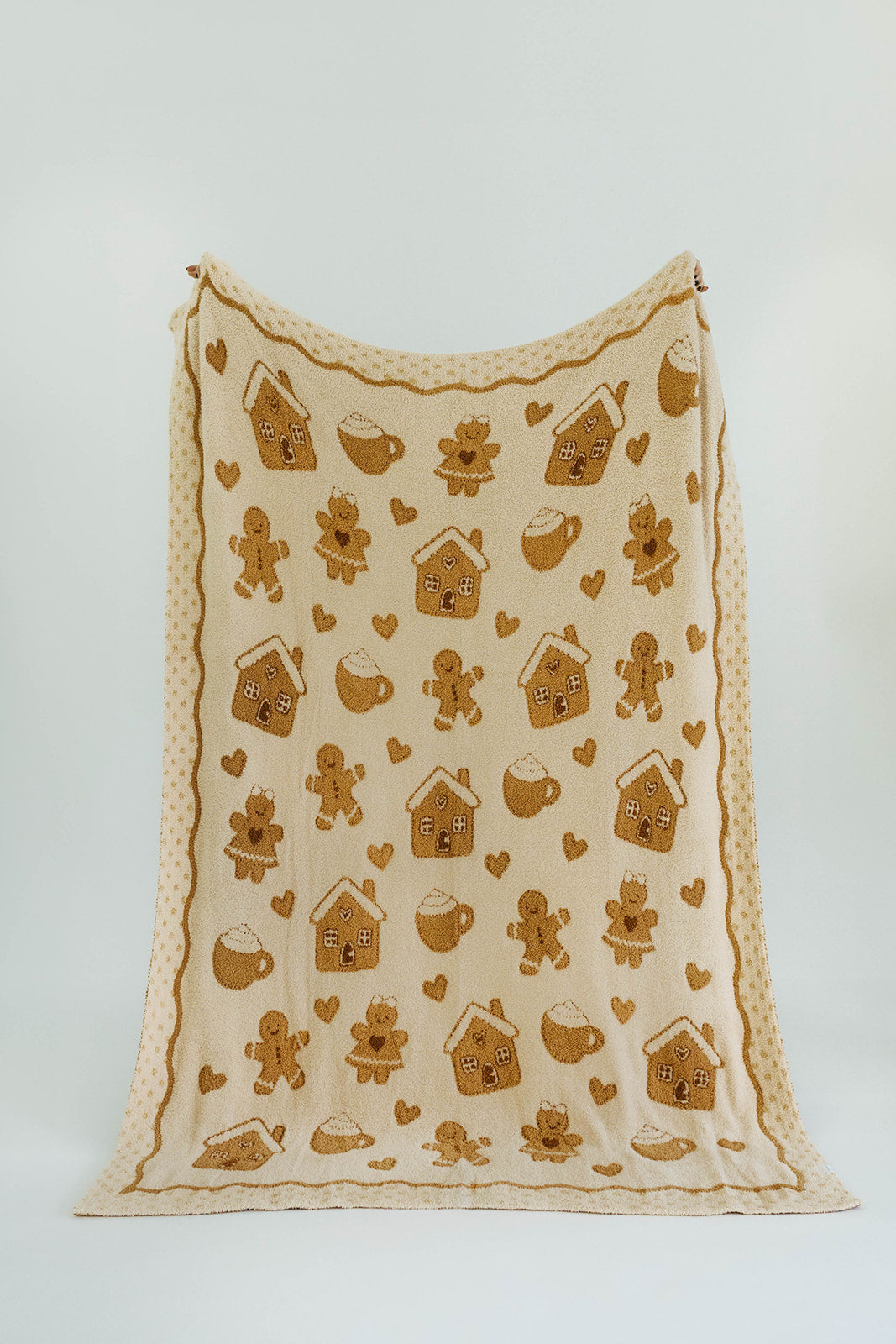 Fabric with gingerbread-themed patterns on a white background