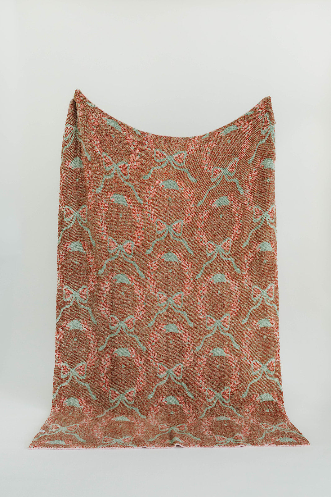 Textile with a pattern of bows on a plain background