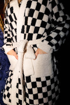 Close view of the fluffy robe pockets and waist tie