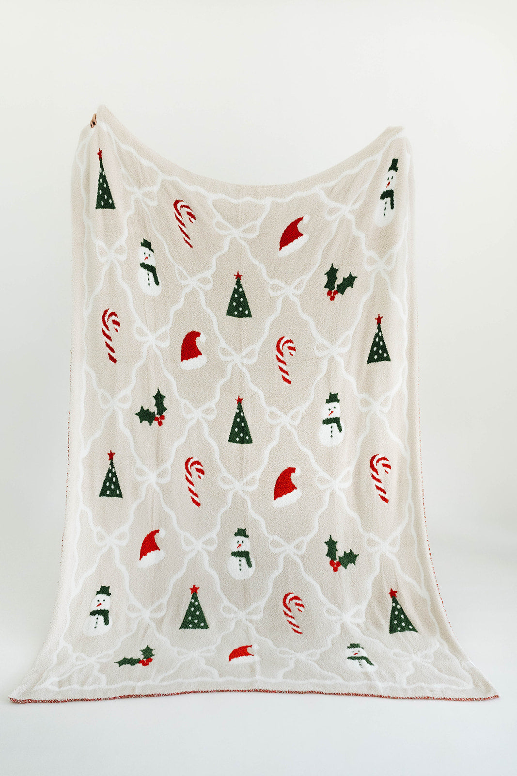 Decorative blanket with Christmas-themed patterns on a white background