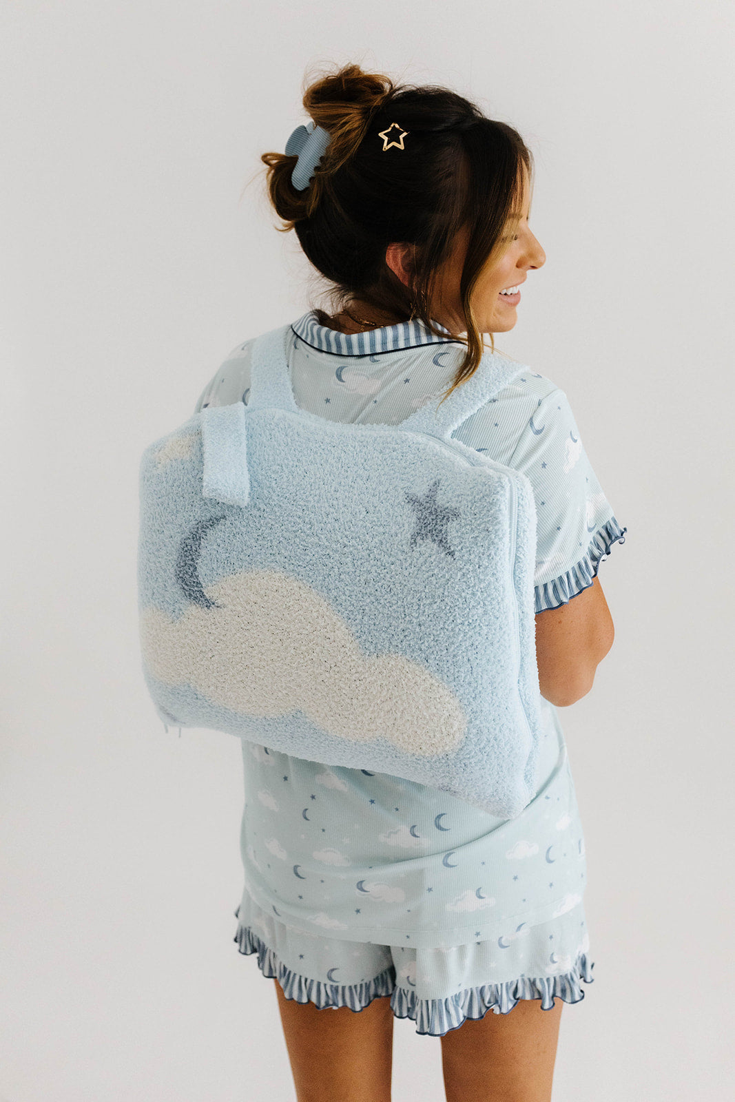 krista smiling with back turned wearing the matching cloud quillow 