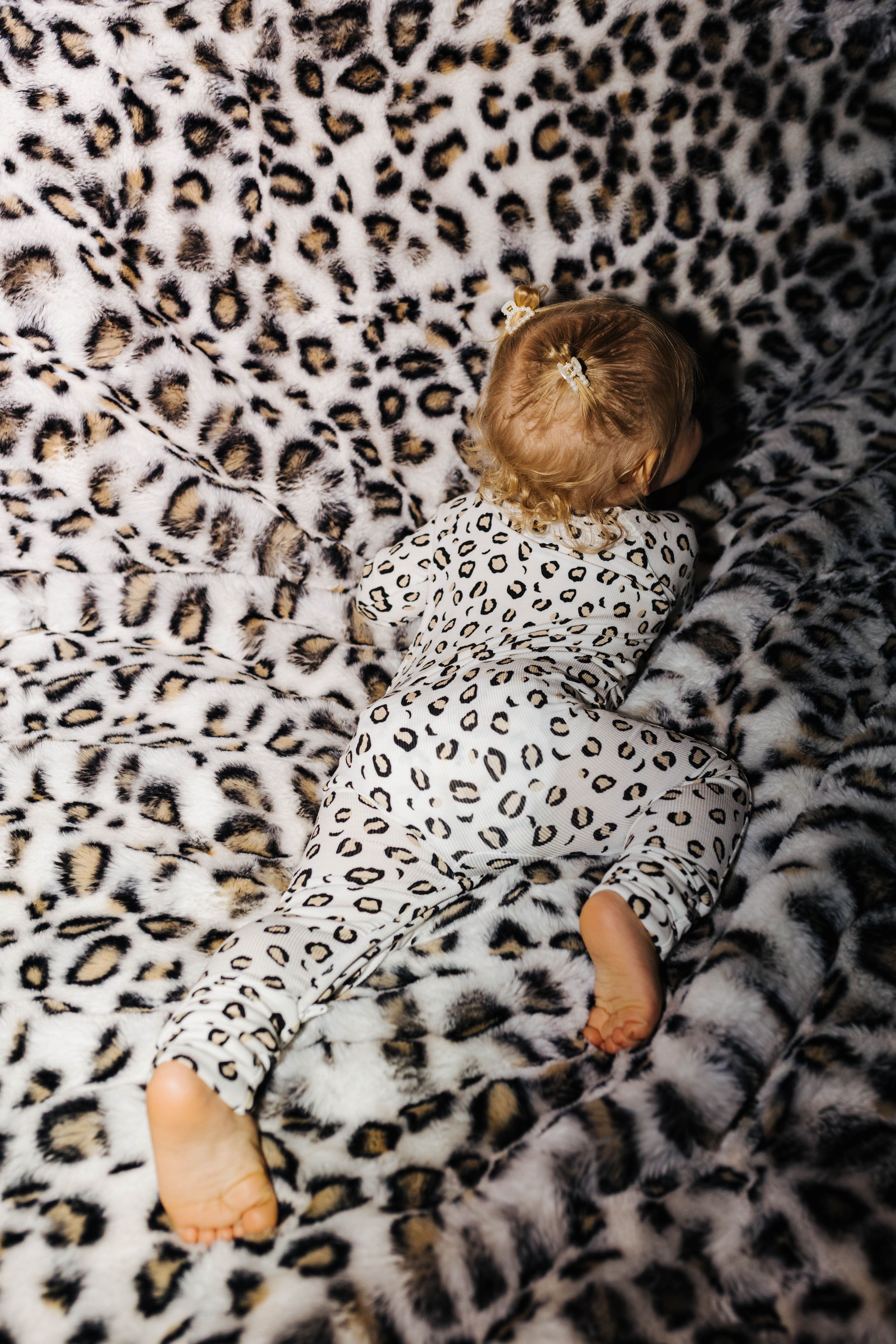 Back view of baby leopard zip pajamas