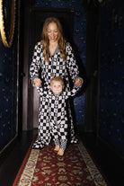 Adult and baby wearing matching Ghost Check pajamas