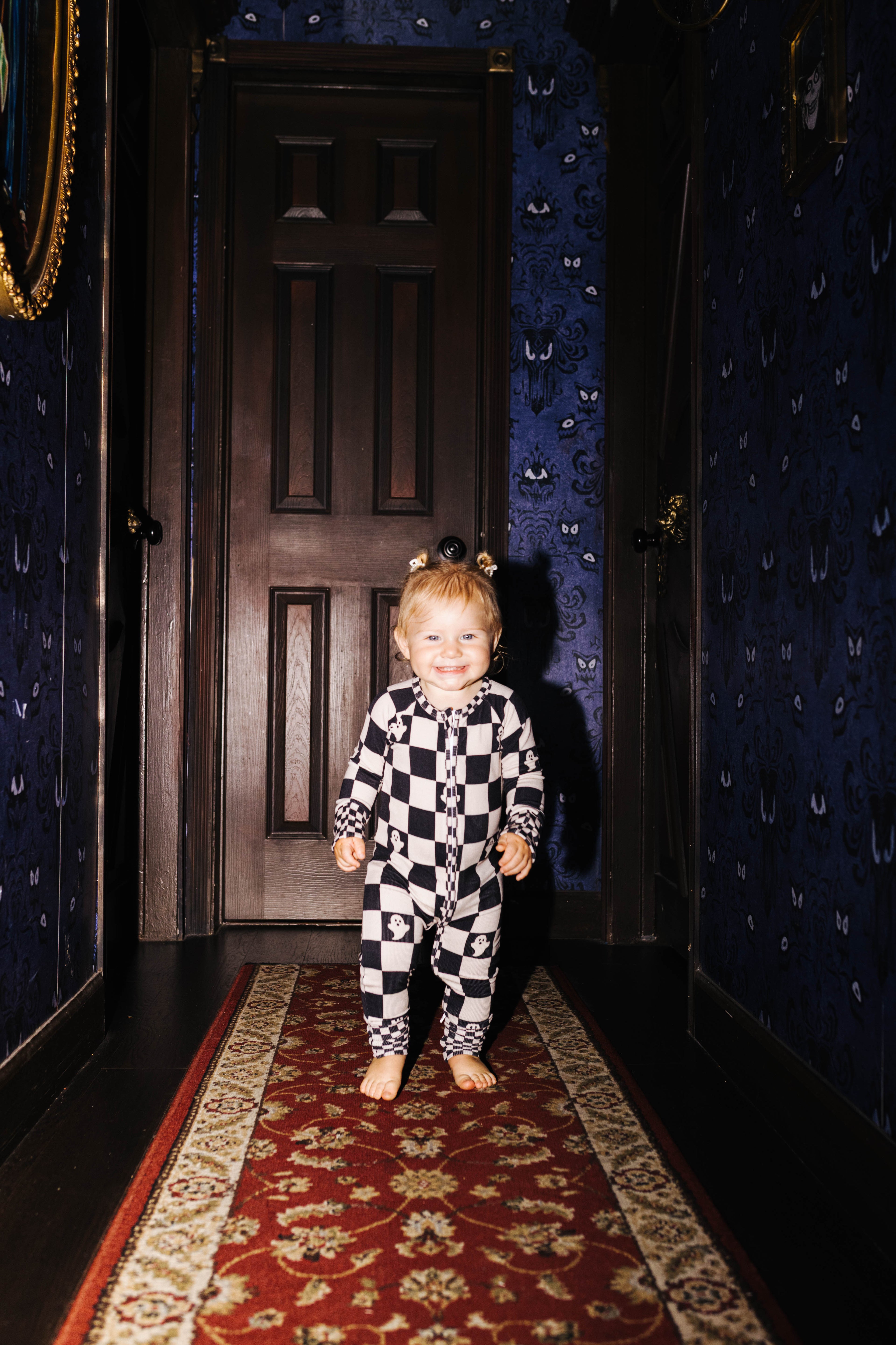 Front view of baby Ghost Check zip pajamas