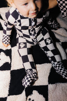 Close view of the zipper and collar on baby Ghost Check pajamas