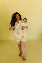 Perla in the 3xl holding her son in the baby pjs