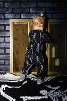 Back view of baby Skelly zip pajamas