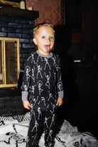 Front view of kids Skelly long pajamas