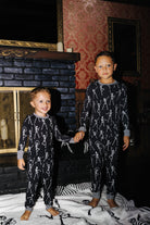 Two children in matching Skelly pajamas