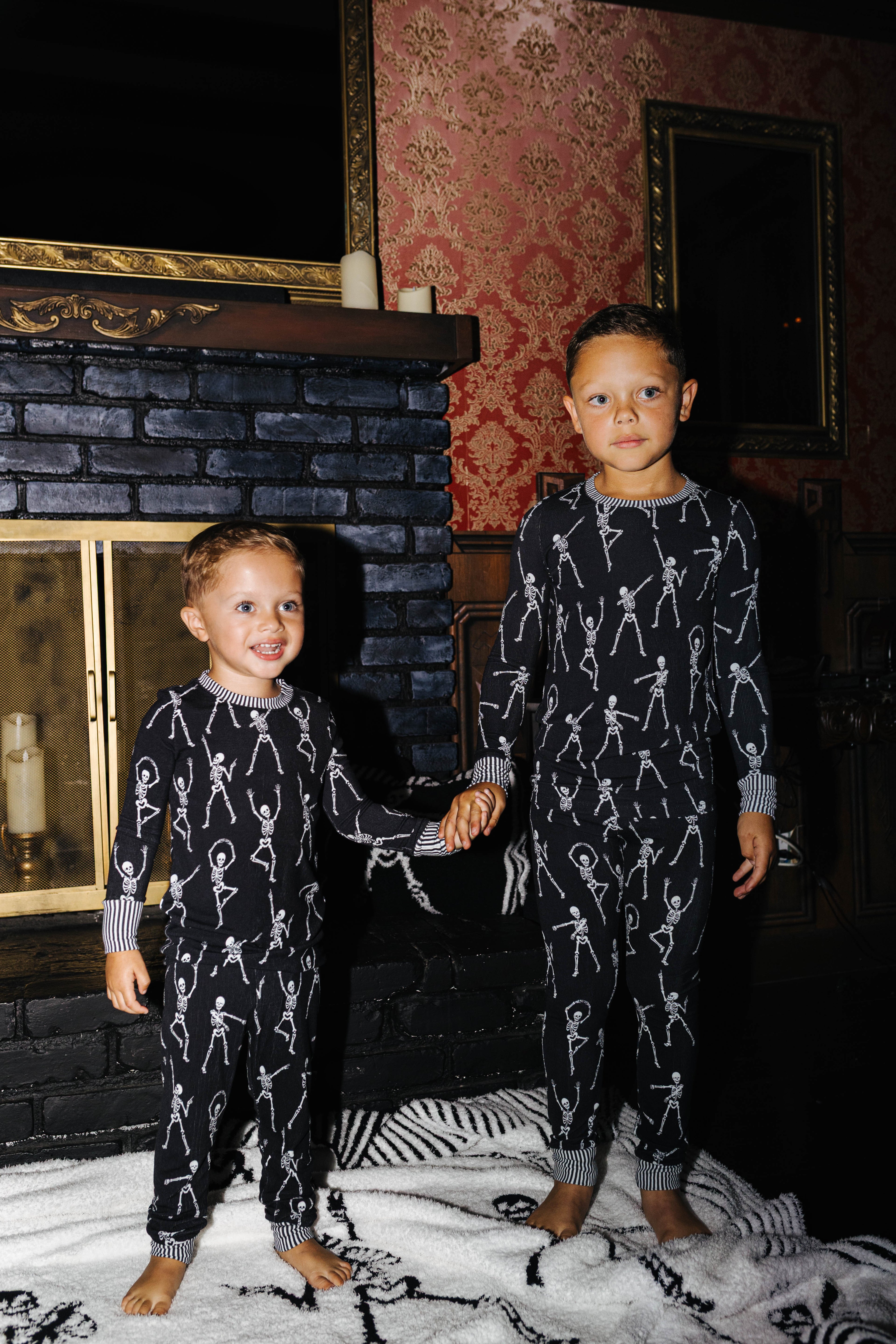 Two children in matching Skelly pajamas