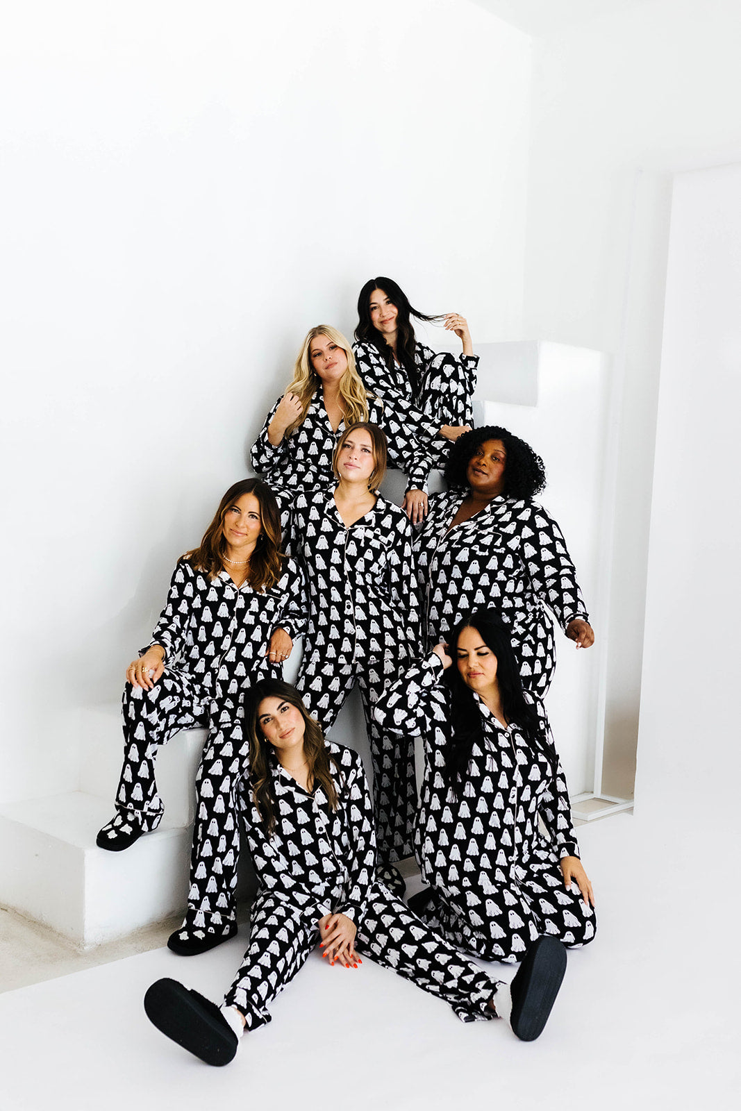 all models staggered on staircase looking at the camera wearing ghost pajamas