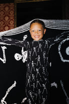 Child holding the Skelly blanket open