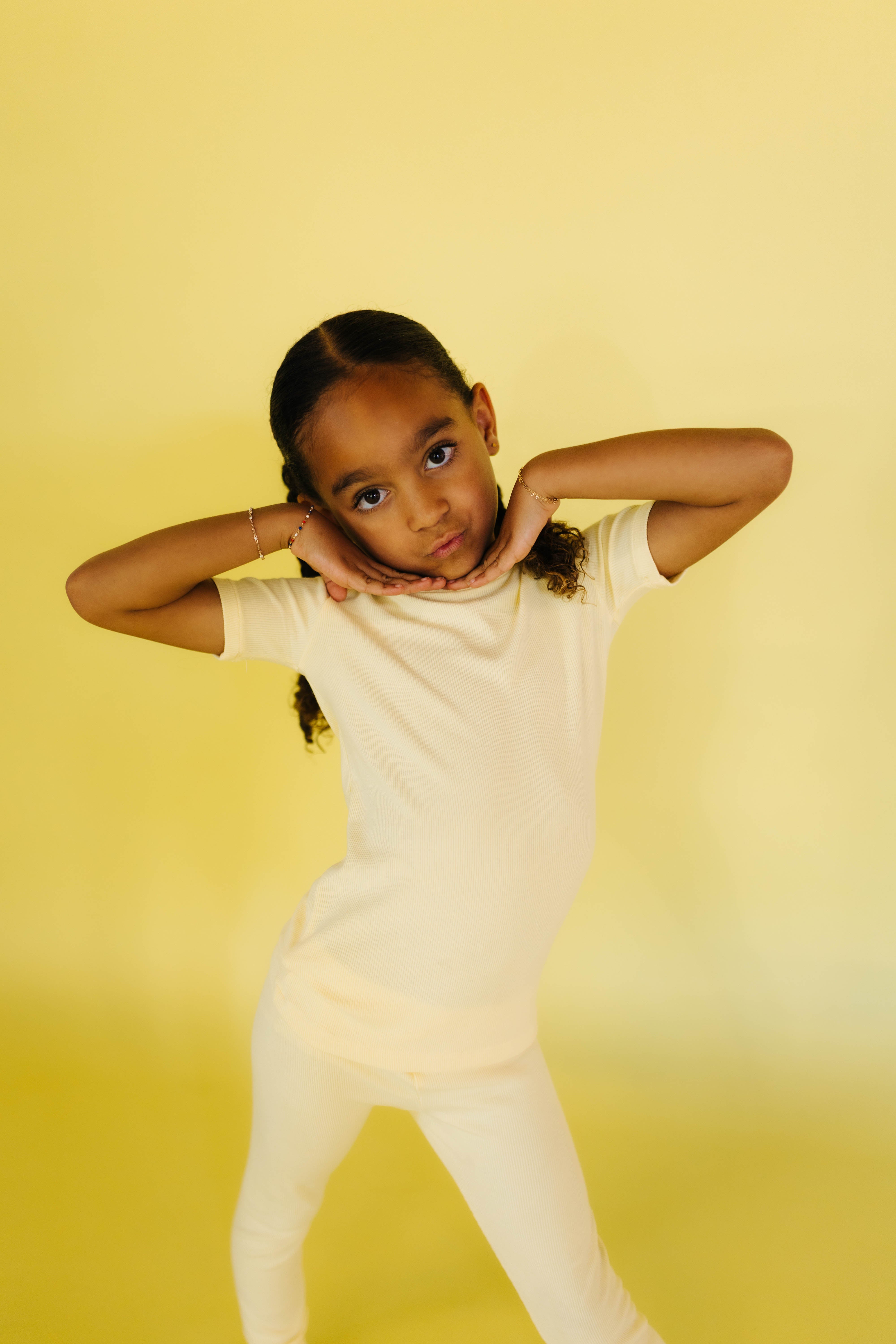 Joie posing with her hands under her face 
