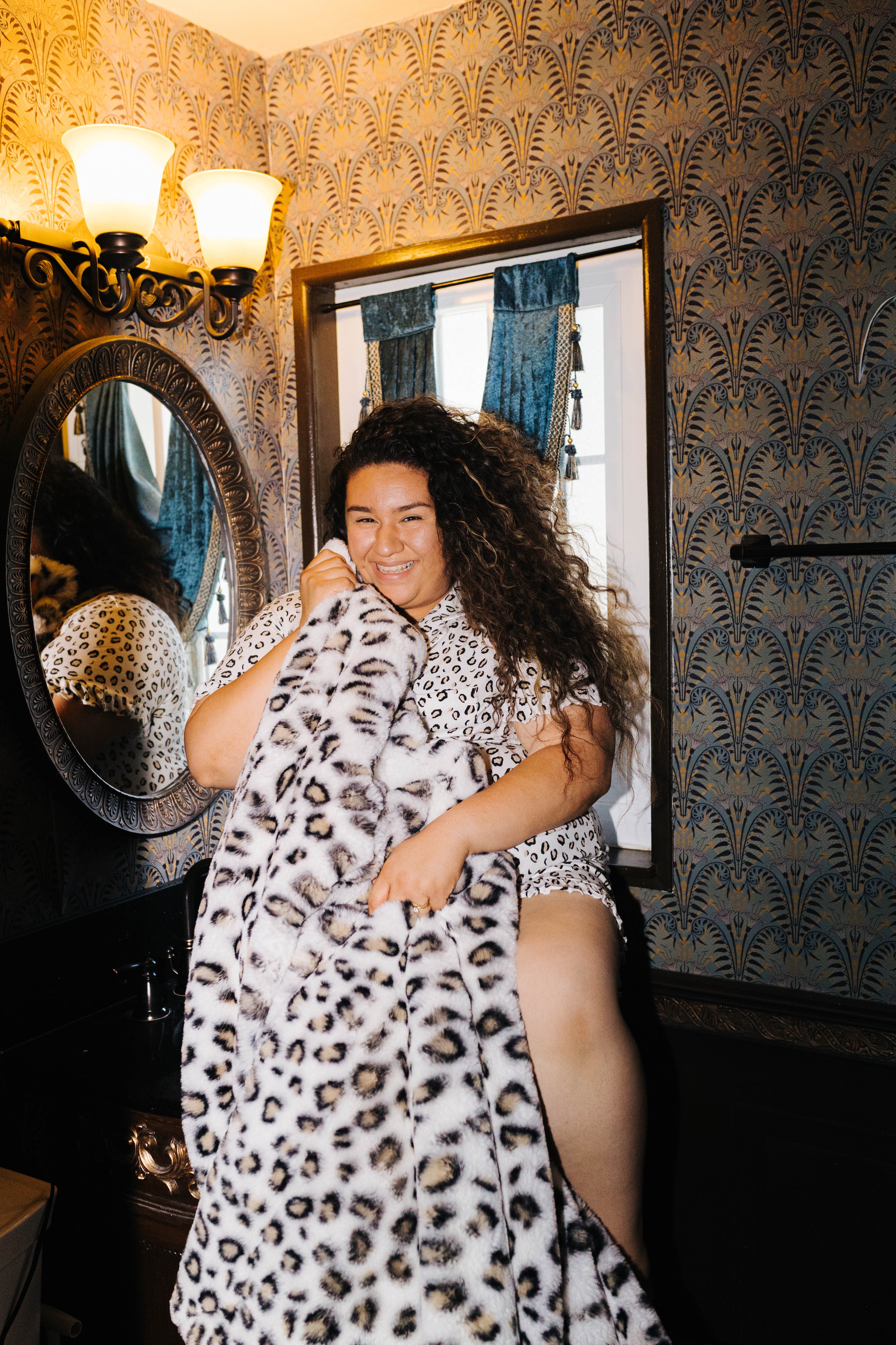 Model holding the leopard blanket in front of her